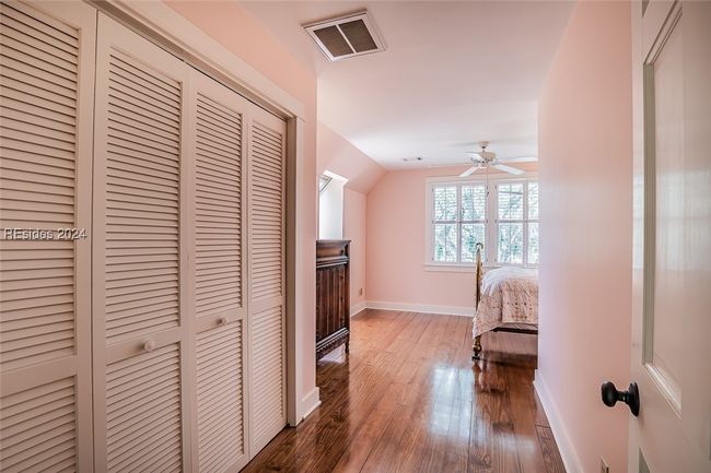 Unfurnished bedroom featuring dark wood-type flooring, a closet, and ceiling fan | Image 34