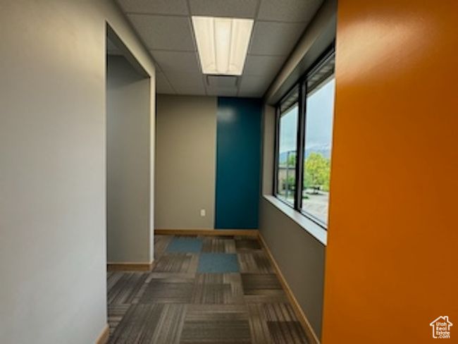 Corridor featuring a paneled ceiling and carpet flooring | Image 30