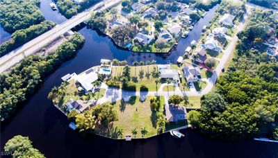 Aerial photo of home (top) and street, on Gulf access canal | Image 1