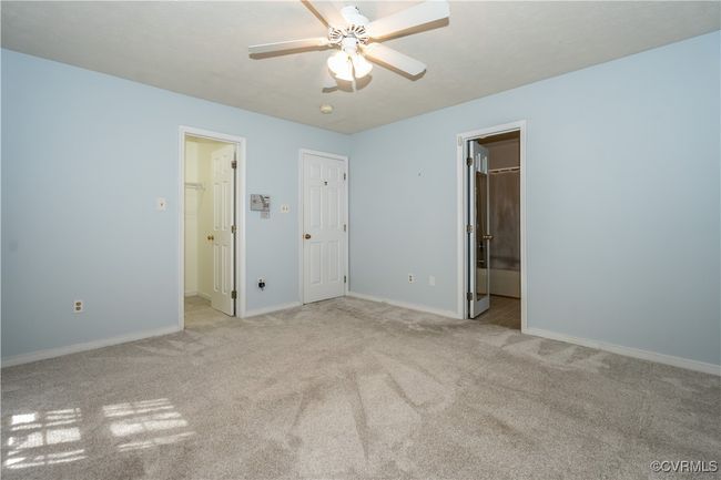 Unfurnished bedroom featuring a spacious closet, carpet, a closet, and ceiling fan | Image 11