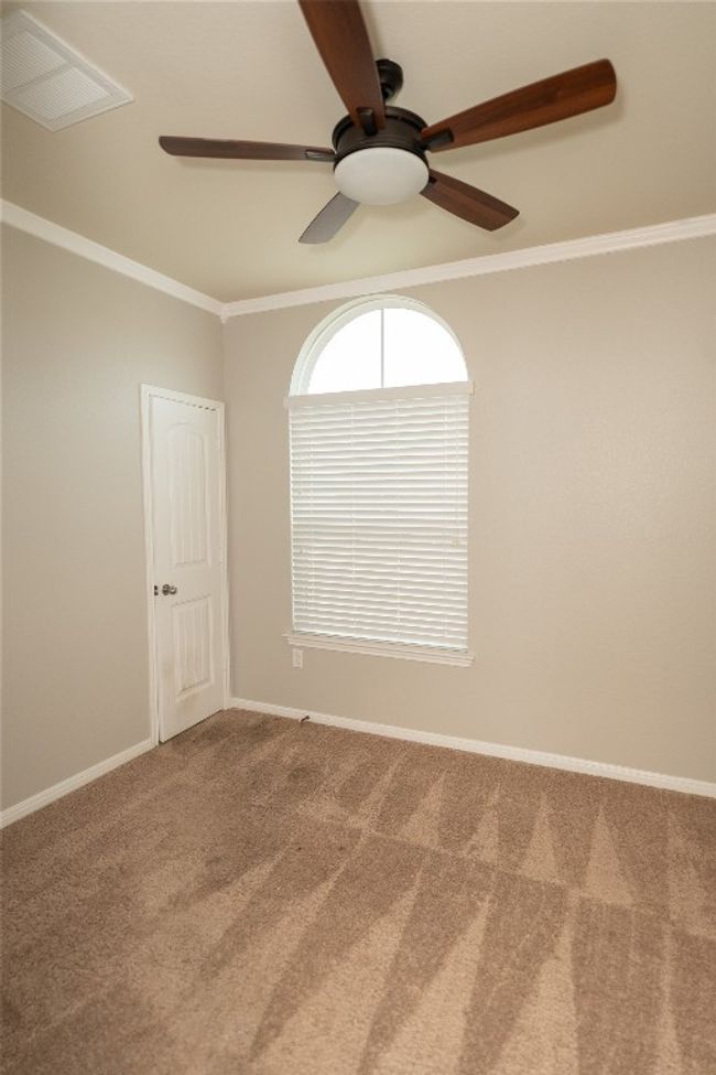 Empty room featuring carpet, ceiling fan, ornamental molding, and baseboards | Image 21
