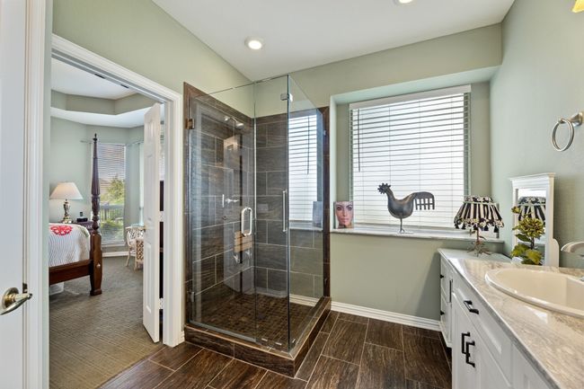 Ensuite bathroom with baseboards, a shower stall, vanity, wood finish floors, and recessed lighting | Image 26