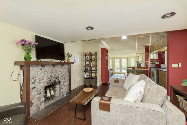 Beautiful river rock fireplace (from the White River) in the living room is the perfect cozy spot year round! | Image 12