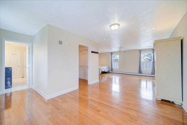 Unfurnished room with baseboards, light wood finished floors, and a ceiling fan | Image 17