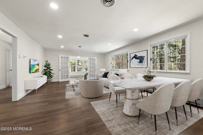 Sunlit living room and dining room with wood floors and recessed lighting | Image 7