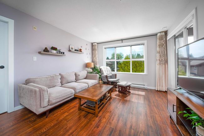 Living area with wood finished floors and baseboards | Image 10
