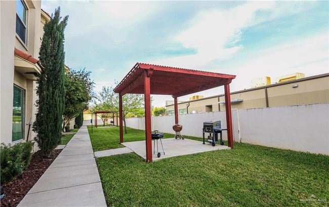 View of yard featuring a pergola and a patio area | Image 28