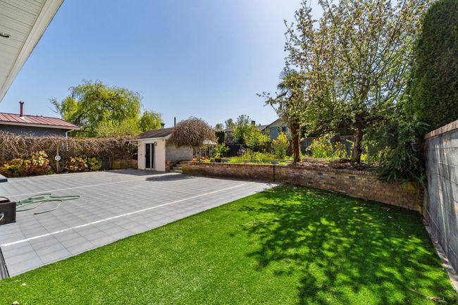 View of yard featuring a fenced backyard, an outbuilding, and a patio area | Image 36