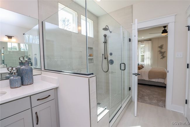 Primary bath with luxury shower, double vanity, linen closet and water closet. | Image 13