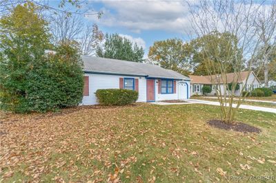 Ranch-style home with a garage and a front yard | Image 2