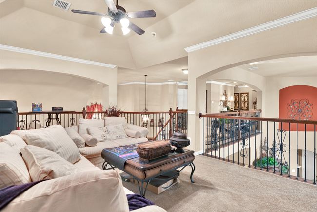 The game room reflects the natural light from the living room and the foyer and enjoys the beautiful wrought iron balusters on the railings. | Image 19