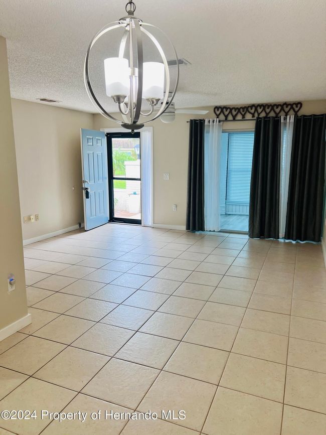 view of living area and front door from dining room | Image 7