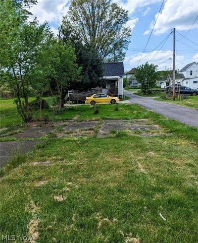 View of front of house from N 5th street featuring concrete parking pads. | Image 2