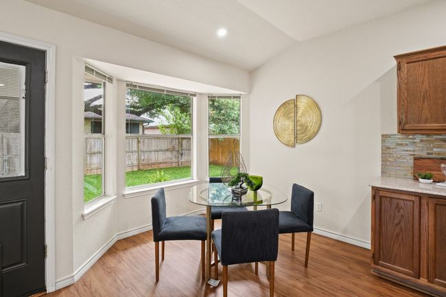 Open to both the kitchen and living room, this dining area is perfect for everyday meals or hosting guests. 9349 Bernoulli Dr., Austin, TX 78748 | Image 14
