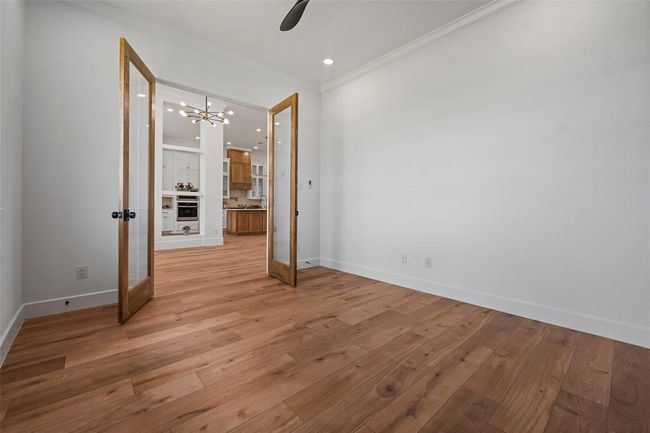 This bright and inviting office space features elegant French doors and beautiful hardwood floors, perfect for productivity and inspiration. | Image 8