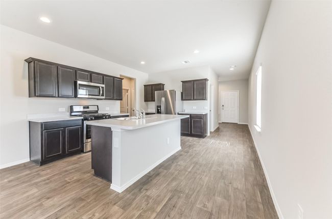 This kitchen offers stainless steel appliance, large island and ample counter space. | Image 4
