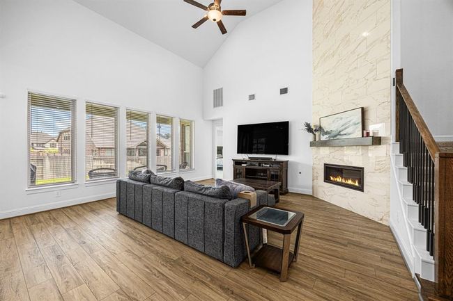 Next you enter the large living room with high ceilings and floor to ceiling fireplace. | Image 18