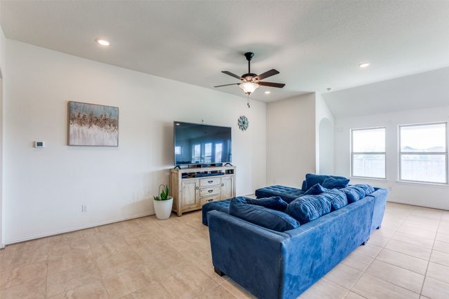 Living room featuring arched walkways, ceiling fan, recessed lighting, and light tile patterned floors | Image 4