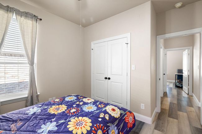 Bedroom with wood finished floors, a closet, and baseboards | Image 21