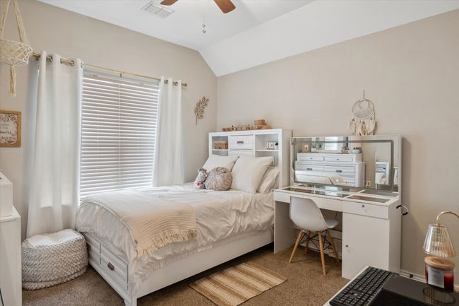 Bedroom with a ceiling fan, lofted ceiling, visible vents, and carpet | Image 24