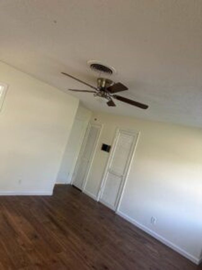 Unfurnished room featuring a ceiling fan and wood finished floors | Image 15