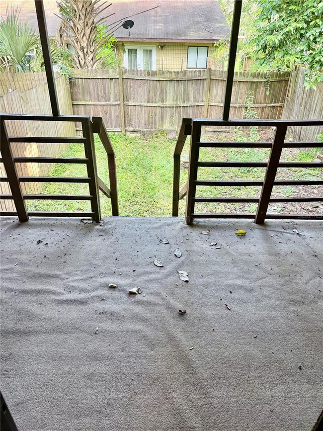 Covered porch with fenced in backyard | Image 12