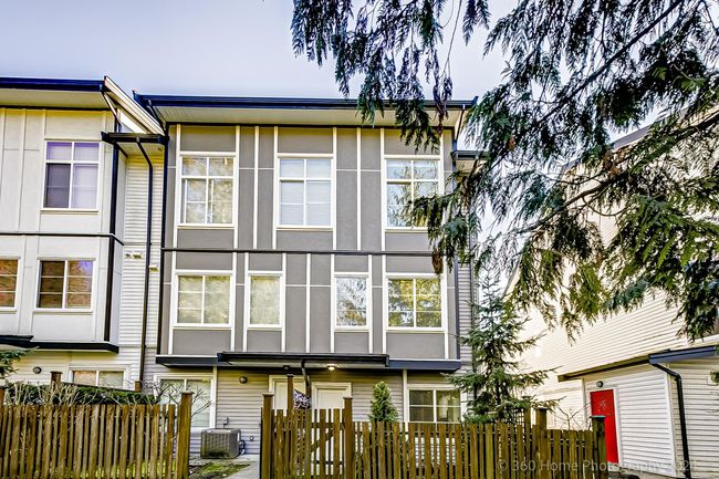 Back of property featuring stucco siding and a fenced front yard | Image 19