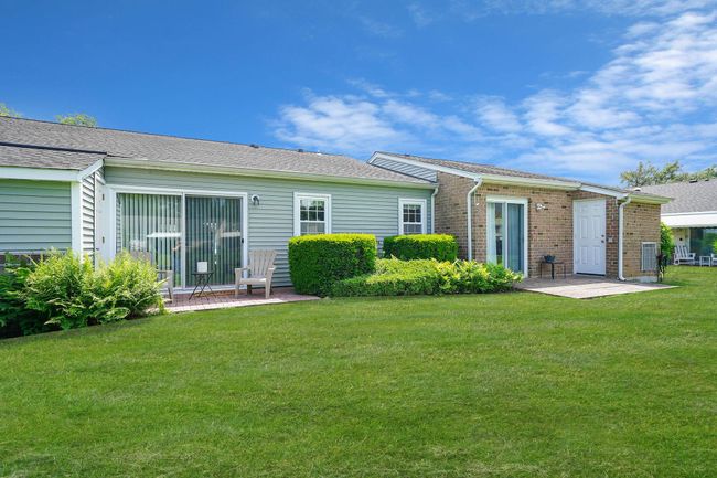 Rear view of property with a patio area, a yard, and brick siding | Image 19