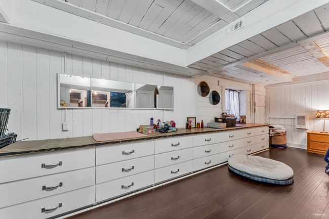 Interior space featuring beam ceiling, wood walls, wood ceiling, and dark wood-style flooring | Image 28
