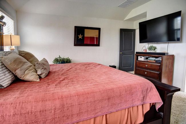 Carpeted bedroom featuring lofted ceiling and visible vents | Image 17