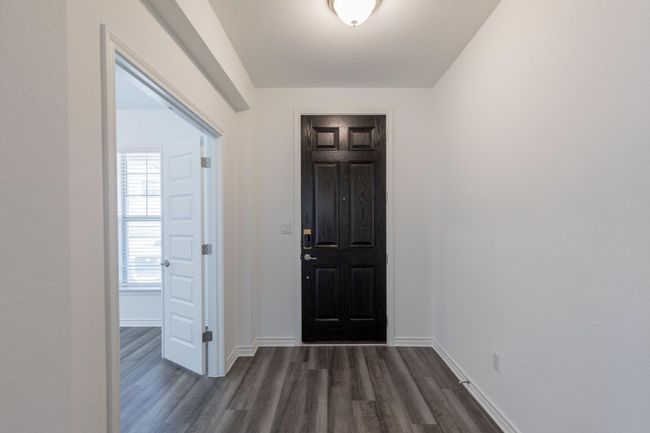 Entryway featuring baseboards and dark wood-style flooring | Image 4