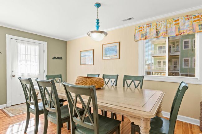 Dining space with crown molding and light wood-type flooring | Image 5