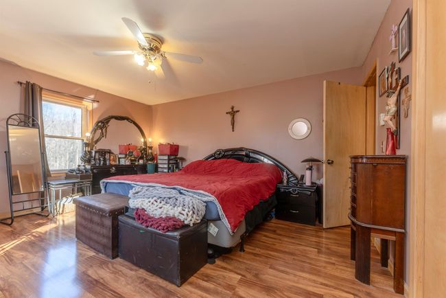 Bedroom featuring wood finished floors and a ceiling fan | Image 15