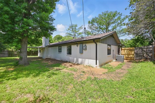 Rear view of property featuring central AC unit, brick siding, and a chimney | Image 15