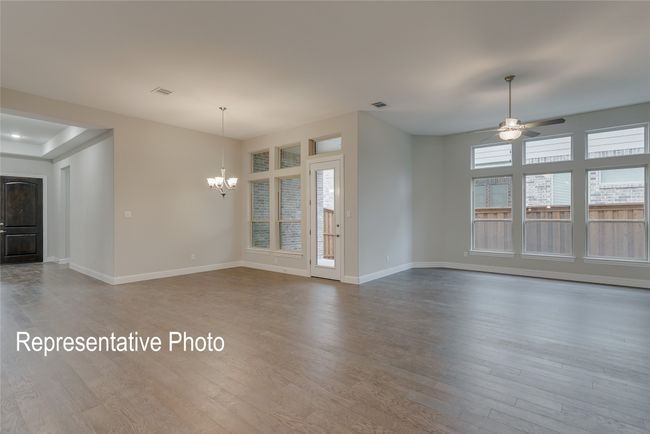 Unfurnished living room featuring a chandelier, wood finished floors, and a ceiling fan | Image 7