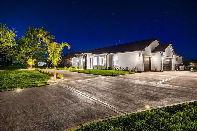 This newly built custom home boasts striking curb appeal with dramatic nighttime lighting, a wide driveway, and a 3-car garage. The sleek architecture and manicured landscaping make a bold first impression, while inside you'll find luxurious finishes and open-concept living designed for comfort and style. This is upscale living redefined—where sophistication and serenity come home. | Image 5