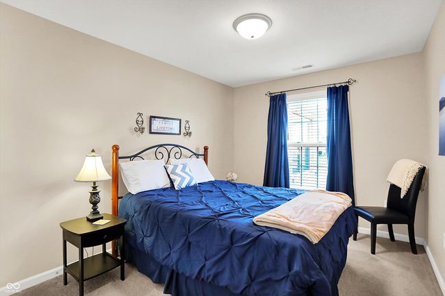 Carpeted bedroom with baseboards | Image 28