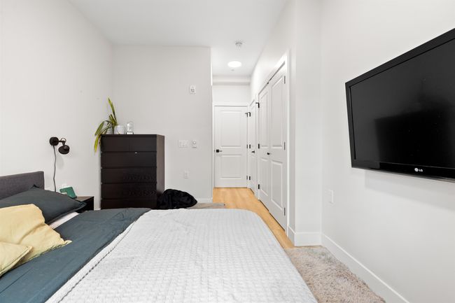 Bedroom with a closet, light wood finished floors, and baseboards | Image 15