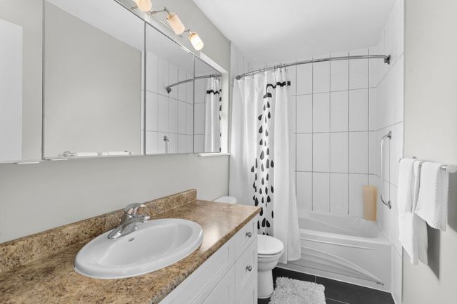 Full bathroom featuring vanity and shower / bath combo with shower curtain | Image 24