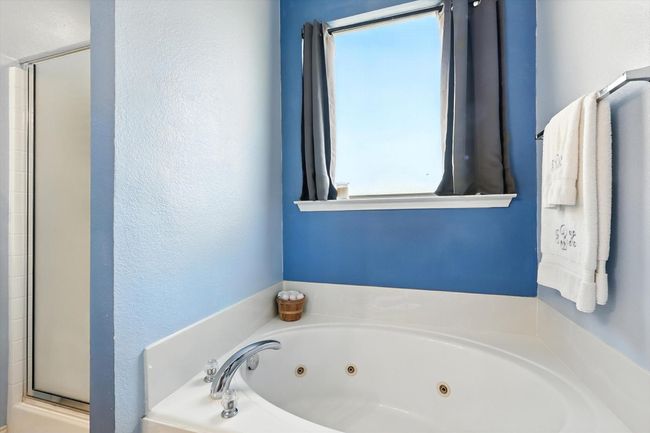 Full bath with a whirlpool tub and a stall shower | Image 10