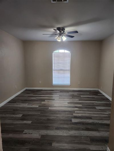 Unfurnished room with ceiling fan and dark hardwood / wood-style floors | Image 2