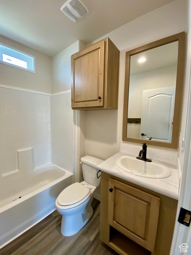 Bathroom with vanity, a bath, and wood finished floors | Image 13