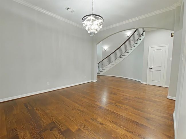 Elegant formal dining room with chandelier located just off the kitchen. | Image 11