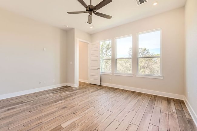 Spare room with light wood finished floors, baseboards, visible vents, recessed lighting, and a ceiling fan | Image 18