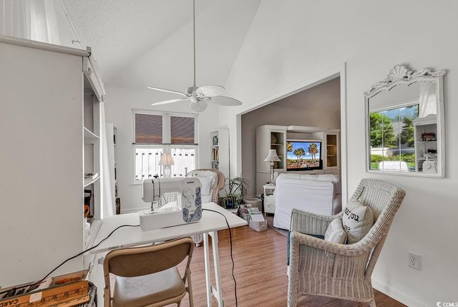 Additional Flex space/Sitting room, just off the Living Room with ceiling fan, wood finished floors, and high vaulted ceiling | Image 19