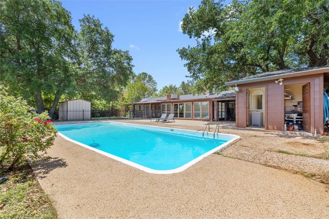 View of pool with a patio | Image 34