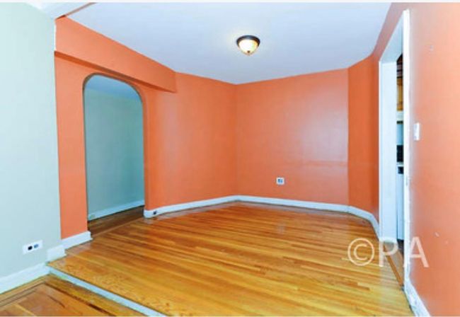 Spare room with baseboards, arched walkways, and light wood-type flooring | Image 6