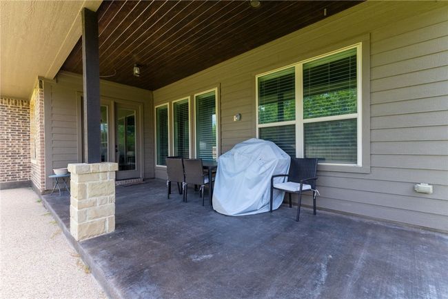An extended patio area offers additional space for outdoor furniture, a grill, and more—ideal for entertaining and enjoying the outdoors. | Image 27