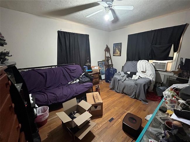 Unfurnished bedroom featuring a ceiling fan, baseboards, and wood finished floors | Image 12