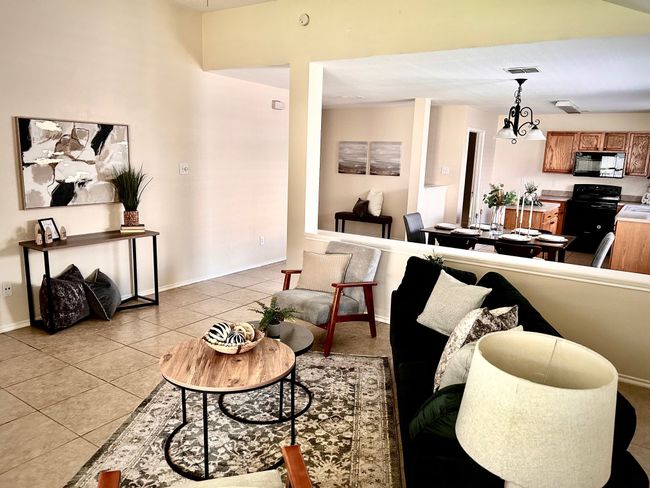 Living area with light tile patterned floors and baseboards | Image 10